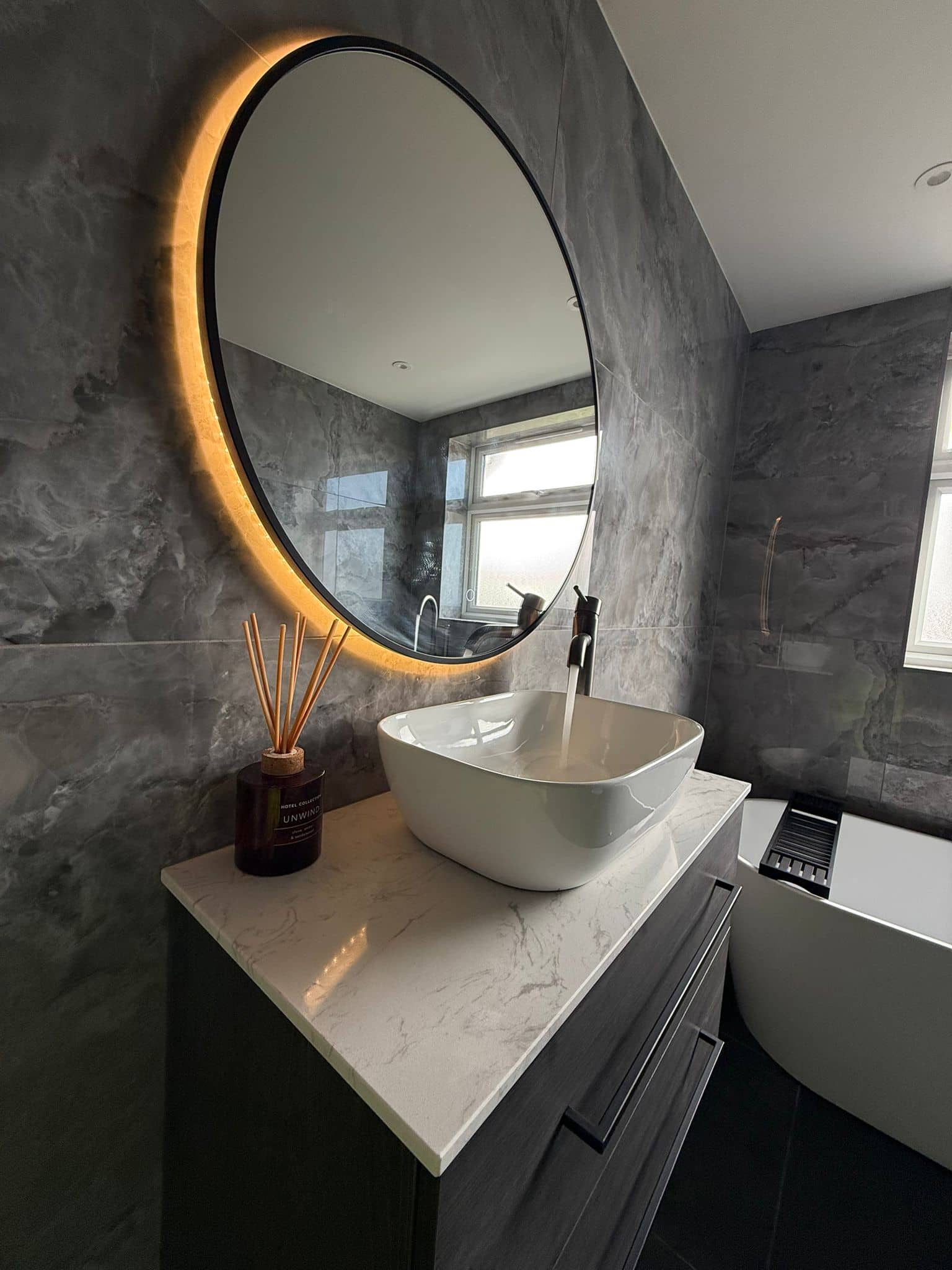 Completed bathroom with marble vanity and backlit mirror, Kent