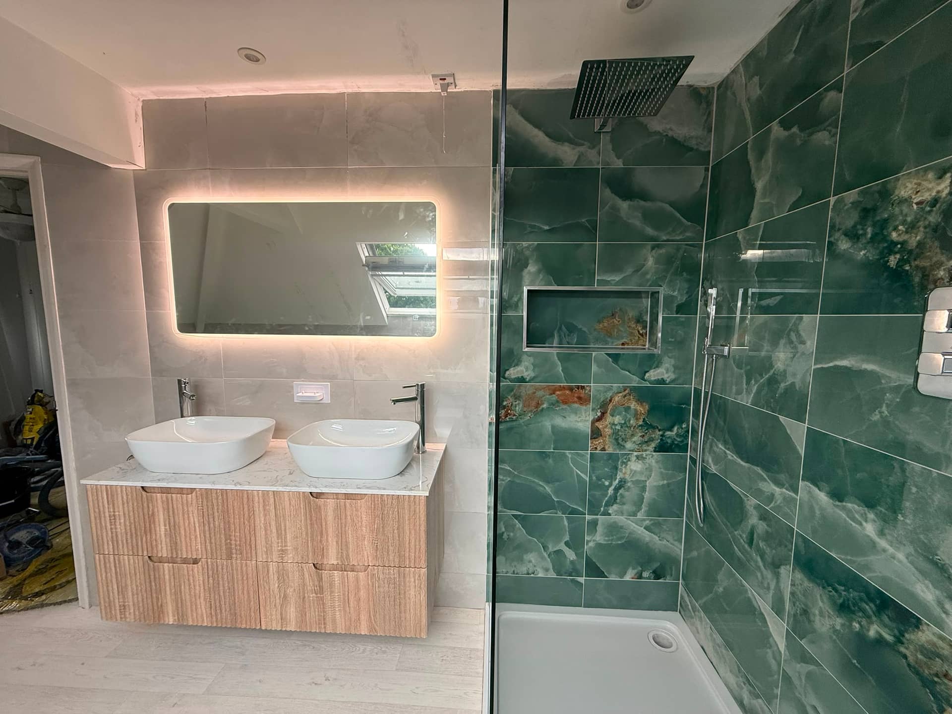 Green tiled bathroom during installation, Kent